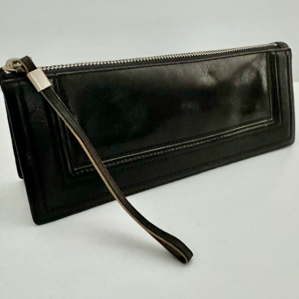 Ellen Tracy Black Leather Clutch with red logo interior.